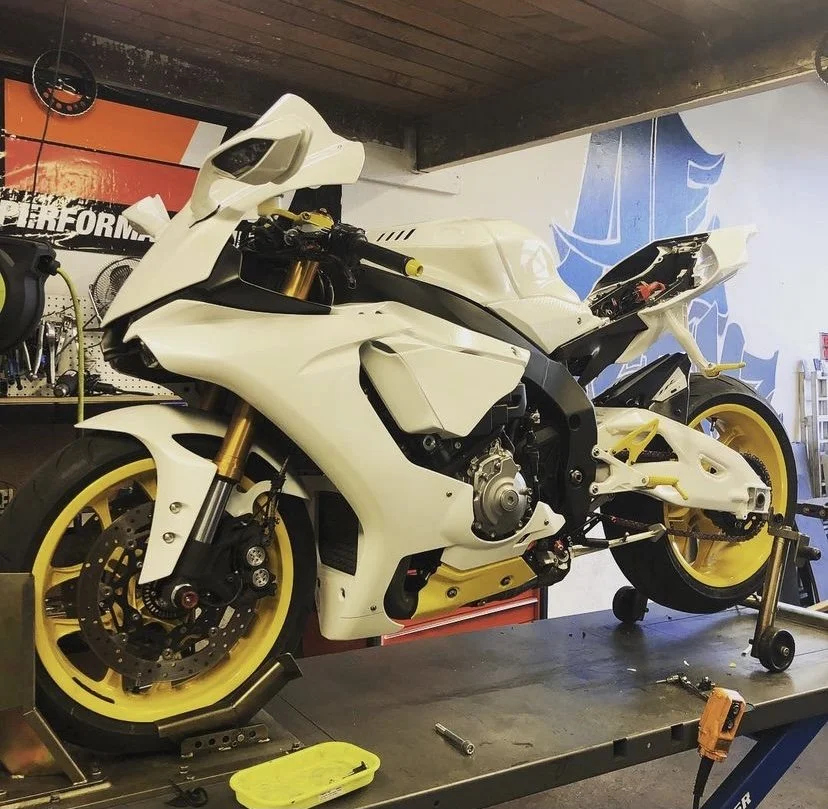 Custom white sport motorcycle inside the AE Kustomz workshop